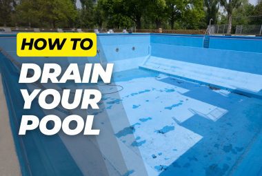 Drained blue concrete swimming pool with bold text reading "How to Drain Your Pool" overlayed on image.
